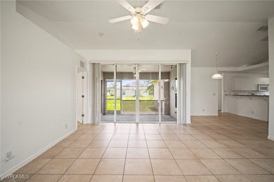 Empty room featuring ceiling fan, light tile patte