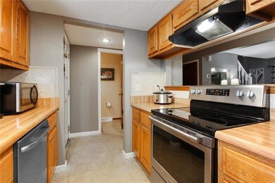 View of kitchen showing entry and half bath in the