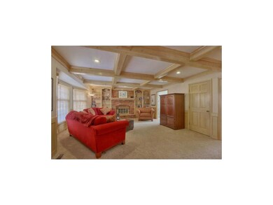 Cozy family room with gas fireplace flanked by spa