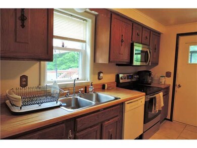 Kitchen. The kitchen features new tile flooring, n