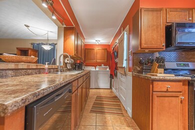 Kitchen featuring backsplash, sink, washer and dry