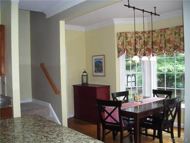 Eat-in area of kitchen by bay window overlooking l