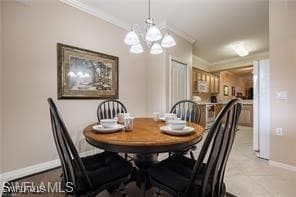 Tiled dining room featuring crown molding and an i