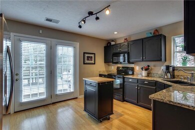Updated kitchen with painted cabinets, granite countertops, new SS DW, newer stove, graphite sink and atrium window.