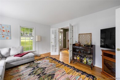Living room with light hardwood / wood-style floors and french doors