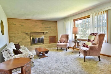Carpeted living room with brick wall