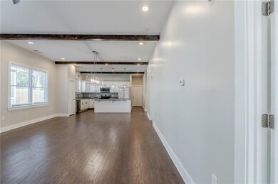 Unfurnished living room with dark wood-style floor