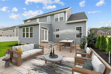Back of property with a patio. Image has been virt
