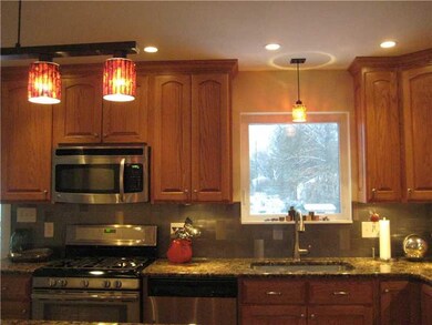 Kitchen. View of rear fenced in back yard through 