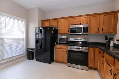 Kitchen with light floors, appliances with stainle