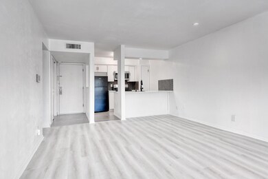 Unfurnished living room featuring light wood-type 