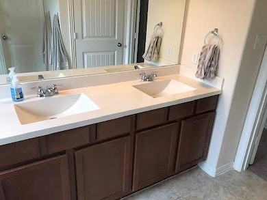 Bathroom featuring double vanity and tile pattern