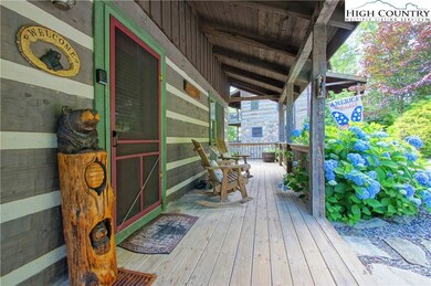 Front porch to welcome you to your cabin! Connects to wrap-around main level deck