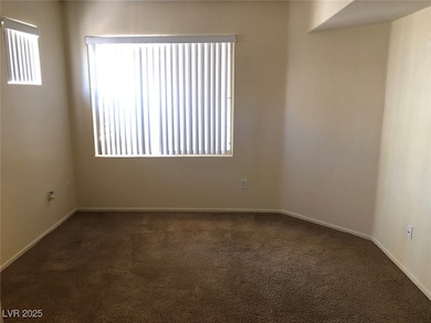 Empty room featuring dark carpet and healthy amoun