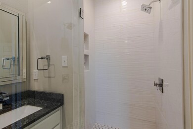 Master Bathroom with vanity and tiled shower