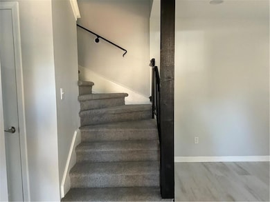 Staircase featuring wood finished floors and baseboards