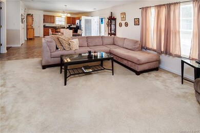 The family room is open to a dining area and the k