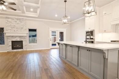 Kitchen with ceiling fan with notable chandelier, 