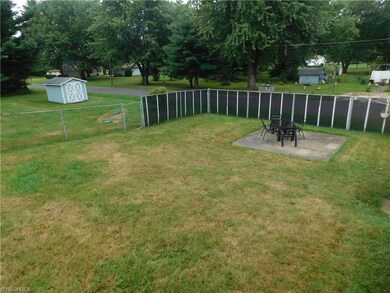 View of the fenced in yard with a cement patio.