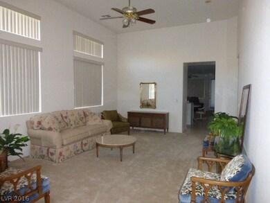 Living room with ceiling fan with attached den are