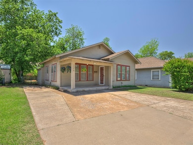 View of front of property with a front lawn, a por