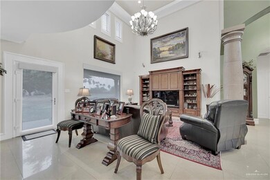 Living area featuring a chandelier, a high ceiling, and light tile patterned floors