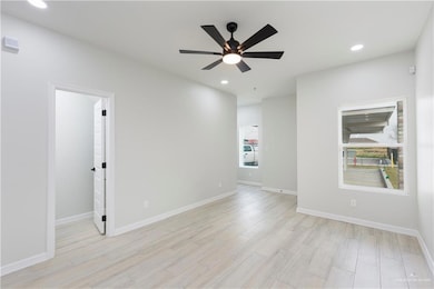 Spare room with light hardwood / wood-style floors and ceiling fan