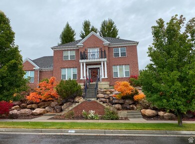 View of front of home with a balcony and fall colors