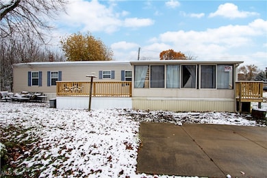 Manufactured / mobile home with a deck and a sunroom