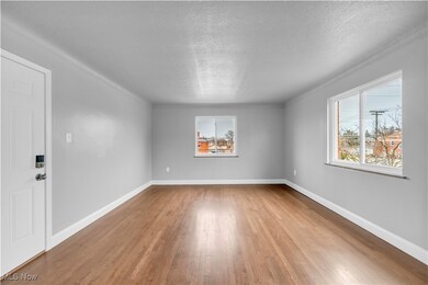 Spare room featuring light hardwood / wood-style floors and a textured ceiling