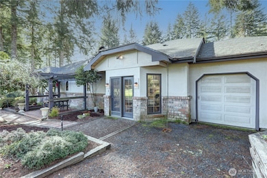 Rear View of the Patio, French Doors to the Dining Room and Golf Cart Storage.