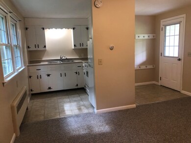From the living room looking towards kitchen and front entrance