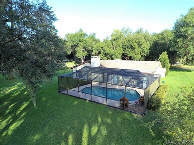Pool entrance from glass-enclosed Florida Room tha