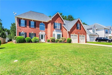 View of front of house with brick siding, a garage, concrete driveway, and a front yard