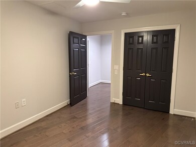 Unfurnished bedroom featuring dark wood-style floo