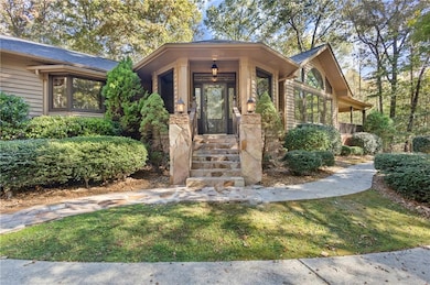 Entrance to property with stoned entry and a yard