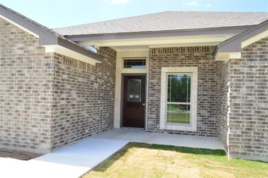 Property entrance featuring brick siding