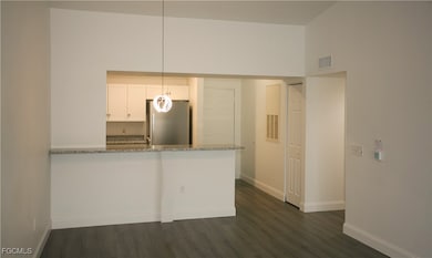 Kitchen featuring freestanding refrigerator, light
