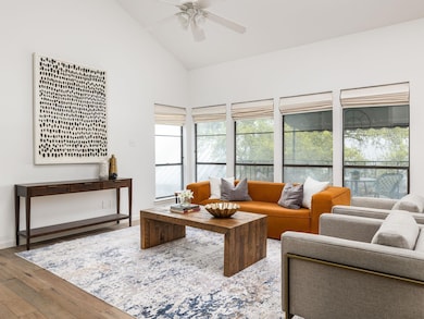 Living room featuring baseboards, high vaulted ce