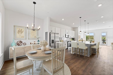 Townhome - Open concept living/dining/kitchen. Virtually Staged.