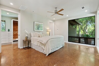 Primary suite with walk in closet and view of the