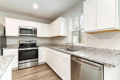 Kitchen with light stone counters, appliances with