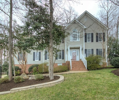 Professionally landscaped yard with hardscaping accents and exterior illumination