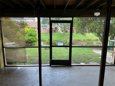 Roofed & screened back patio overlooking yard and water