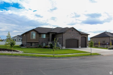 French provincial home with brick siding, driveway, an attached garage, and stucco siding