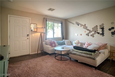Living area with wood finished floors and baseboar