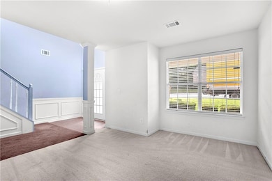 Empty room featuring carpet and baseboards
