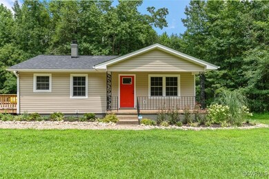 View of front of home with a front lawn and covere
