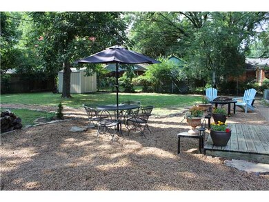 Beautifully landscaped yard with storage building.