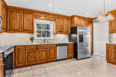 Hardwood cabinets and pantry with rollout shelves.